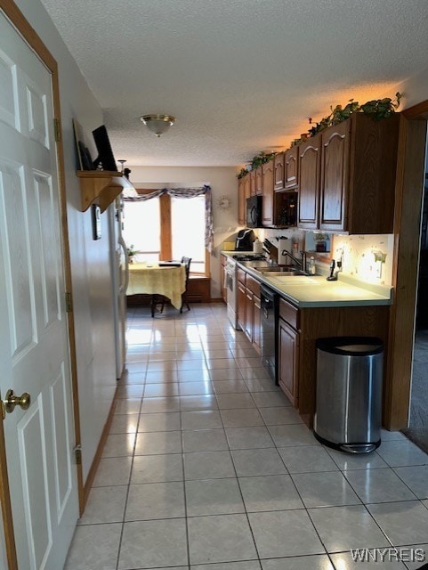 208 Angle Rd, West Seneca, NY 14224 - kitchen with a textured ceiling, light countertops, light tile patterned flooring, black appliances, and dark brown cabinets