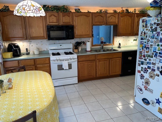 208 Angle Rd, West Seneca, NY 14224 - kitchen featuring black appliances, light countertops, and decorative backsplash