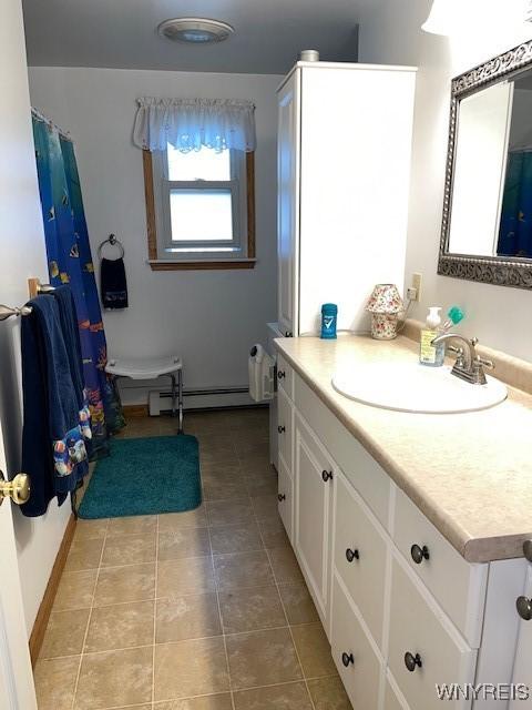 208 Angle Rd, West Seneca, NY 14224 - bathroom with a baseboard heating unit, vanity, and tile patterned floors