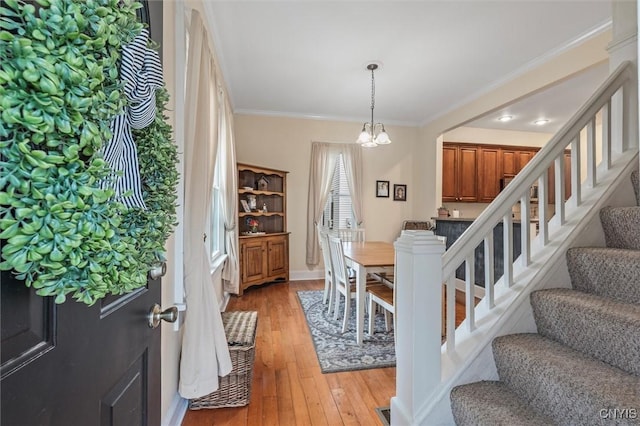 37 Augustus St, Auburn, NY 13021 - foyer with stairs, light wood-type flooring, a chandelier, and crown molding