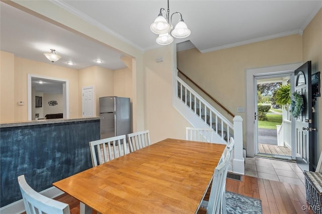 37 Augustus St, Auburn, NY 13021 - dining room with wood-type flooring, ornamental molding, a chandelier, and stairway