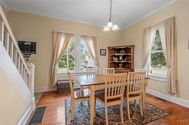 37 Augustus St, Auburn, NY 13021 - dining room with plenty of natural light, light wood-type flooring, crown molding, and a chandelier