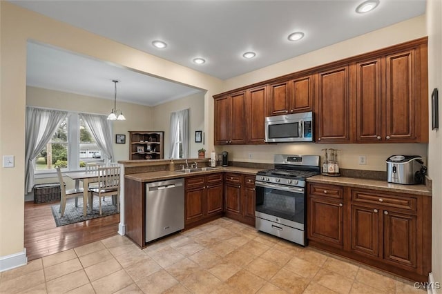 37 Augustus St, Auburn, NY 13021 - kitchen featuring appliances with stainless steel finishes, decorative light fixtures, a peninsula, a chandelier, and ornamental molding