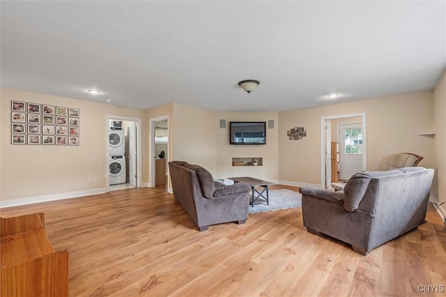 37 Augustus St, Auburn, NY 13021 - living room featuring stacked washer / dryer and light wood-type flooring