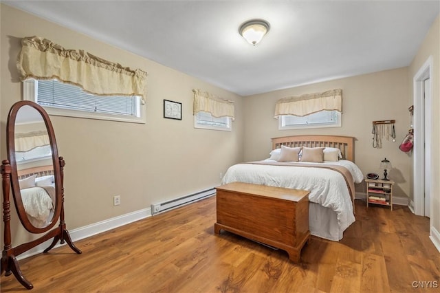 37 Augustus St, Auburn, NY 13021 - bedroom with a baseboard radiator, multiple windows, and wood finished floors