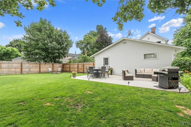 37 Augustus St, Auburn, NY 13021 - back of property featuring a fenced backyard, a patio area, an outdoor hangout area, and a chimney