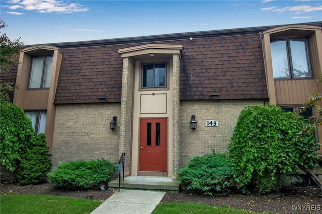 145 Charter Oaks Dr Unit 2, Amherst, NY 14228 - entrance to property featuring brick siding, mansard roof, and roof with shingles
