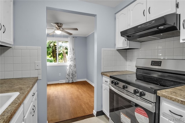 145 Charter Oaks Dr Unit 2, Amherst, NY 14228 - kitchen with electric range, under cabinet range hood, ceiling fan, white cabinets, and decorative backsplash