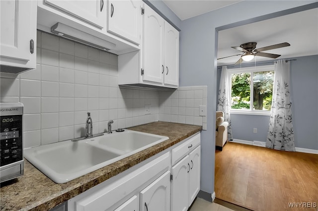 145 Charter Oaks Dr Unit 2, Amherst, NY 14228 - kitchen featuring white cabinetry, decorative backsplash, a ceiling fan, and light wood-style flooring