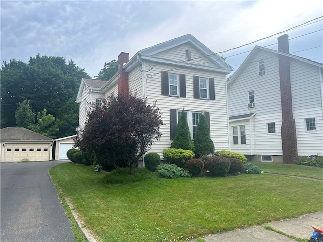 73 Platt St, Hornell, NY 14843 - view of front of property with a chimney, an outbuilding, a garage, and a front yard