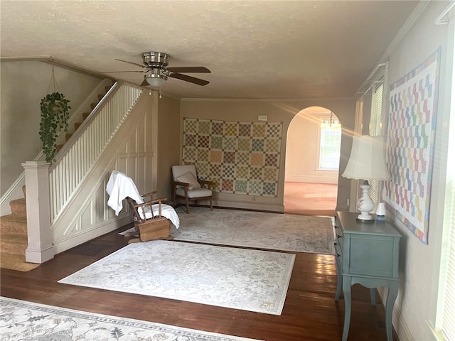 73 Platt St, Hornell, NY 14843 - unfurnished room featuring stairway, wood finished floors, arched walkways, ceiling fan, and ornamental molding