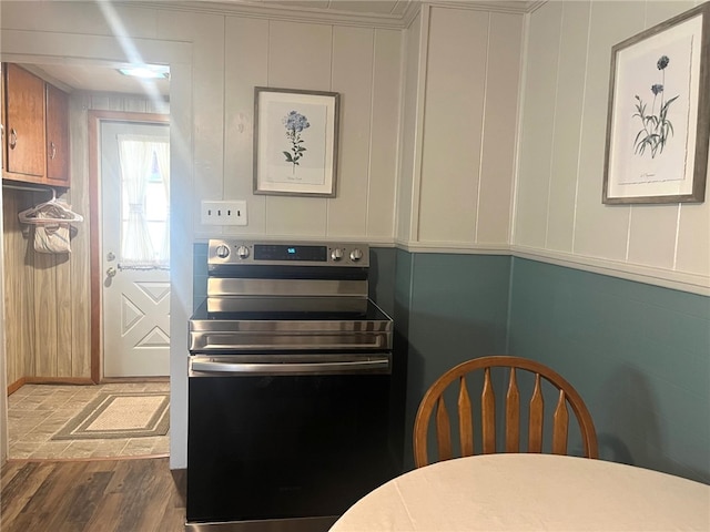 73 Platt St, Hornell, NY 14843 - kitchen featuring electric stove, wood finished floors, and a decorative wall
