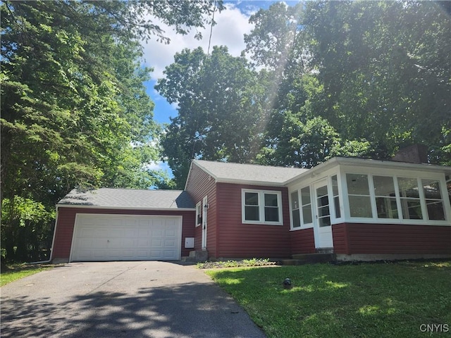 127 Austin Ave, Syracuse, NY 13207 - ranch-style house featuring asphalt driveway, a garage, a sunroom, and a front lawn