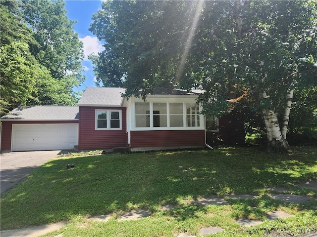 127 Austin Ave, Syracuse, NY 13207 - bungalow featuring concrete driveway, a front lawn, an attached garage, a sunroom, and roof with shingles