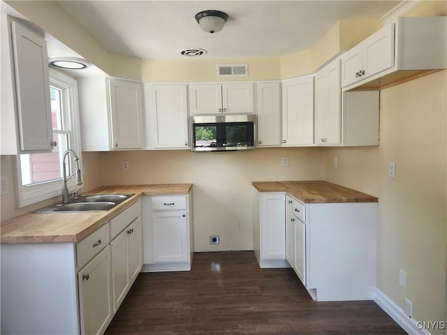 127 Austin Ave, Syracuse, NY 13207 - kitchen featuring stainless steel microwave, dark wood finished floors, white cabinetry, and light countertops