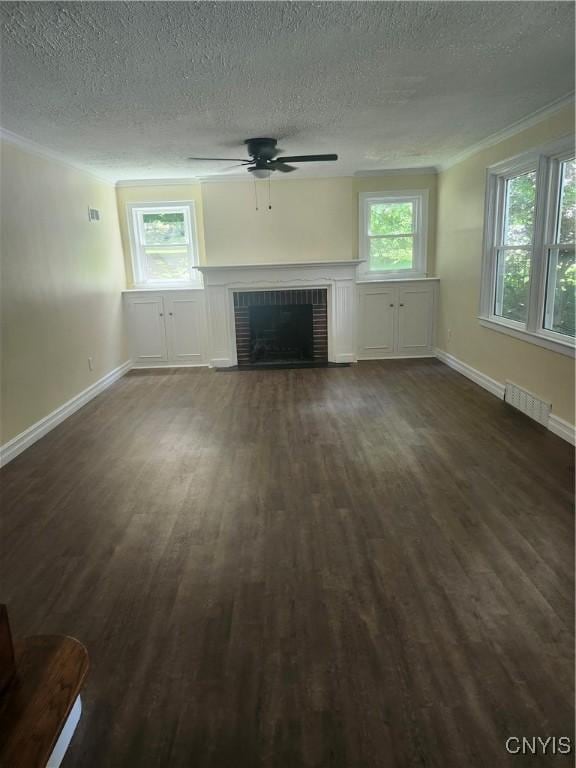 127 Austin Ave, Syracuse, NY 13207 - unfurnished living room with ornamental molding, ceiling fan, dark wood finished floors, a fireplace, and a textured ceiling