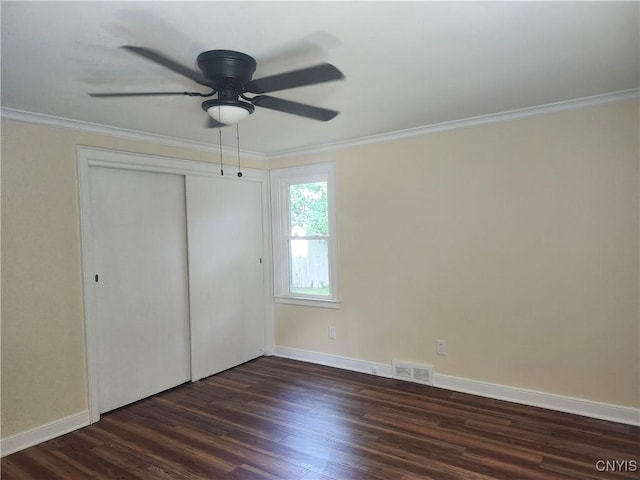 127 Austin Ave, Syracuse, NY 13207 - unfurnished bedroom with crown molding, dark wood-style flooring, a closet, and a ceiling fan