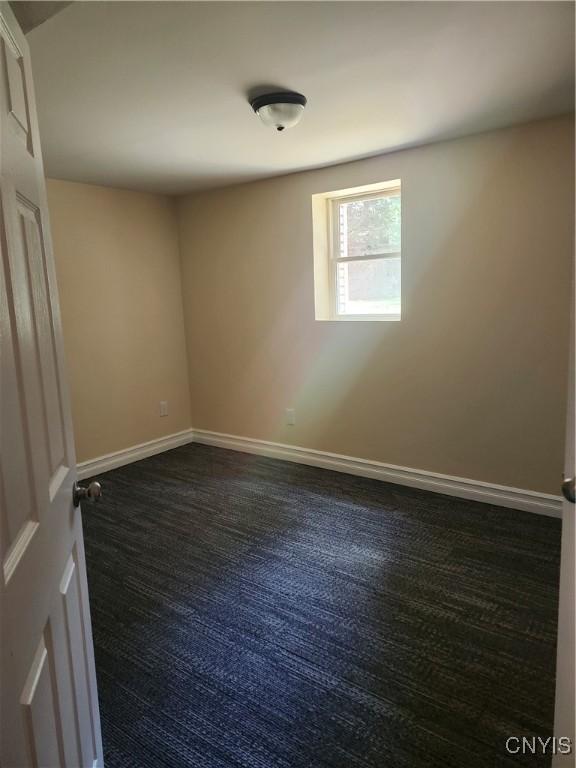 127 Austin Ave, Syracuse, NY 13207 - empty room with baseboards and dark colored carpet