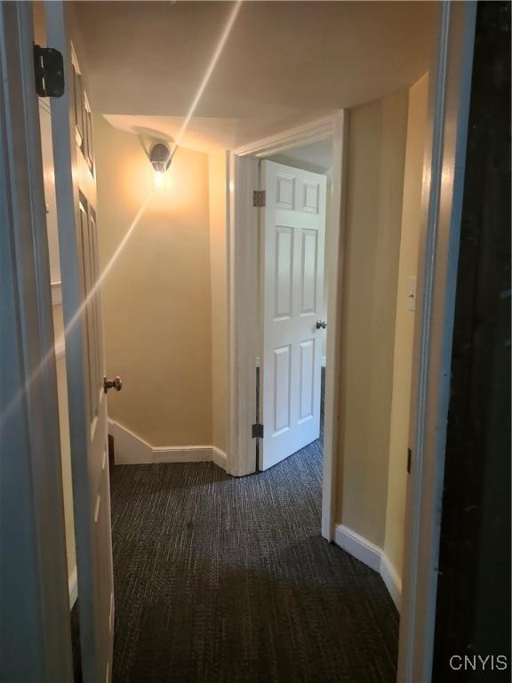 127 Austin Ave, Syracuse, NY 13207 - corridor featuring dark carpet and baseboards