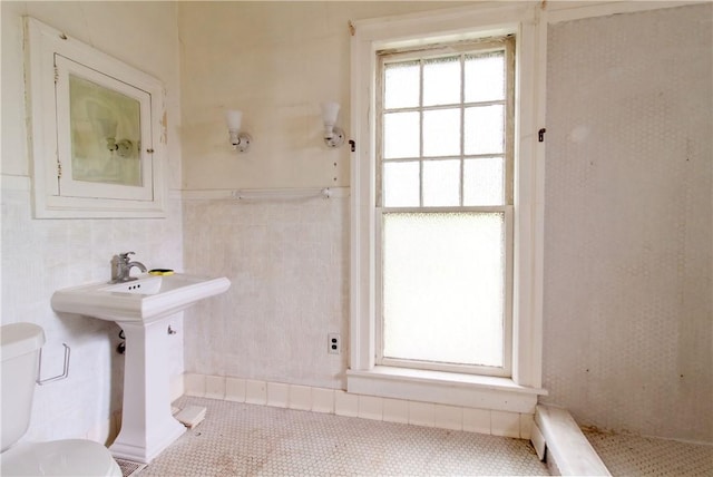 27 E Main St, Sodus, NY 14551 - bathroom featuring tile walls, tile patterned flooring, and wainscoting