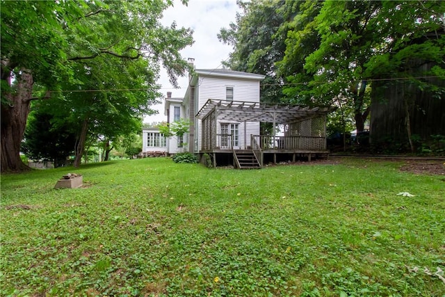 27 E Main St, Sodus, NY 14551 - rear view of house with a pergola, a chimney, a deck, and a lawn