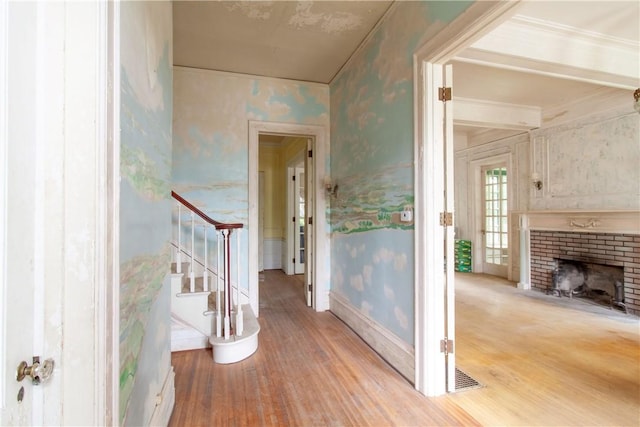 27 E Main St, Sodus, NY 14551 - hall with light wood-type flooring, stairs, wallpapered walls, and ornamental molding