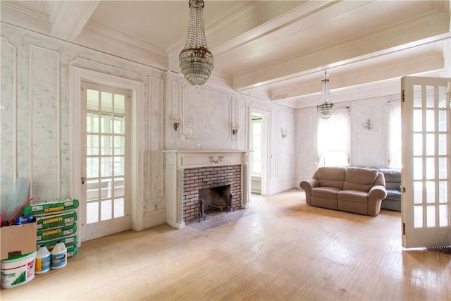27 E Main St, Sodus, NY 14551 - living room featuring wood finished floors, a chandelier, ornamental molding, beamed ceiling, and a fireplace