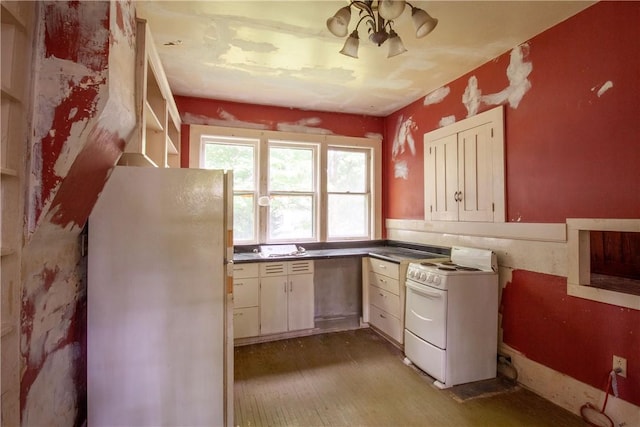 27 E Main St, Sodus, NY 14551 - kitchen with white appliances, wood finished floors, and dark countertops