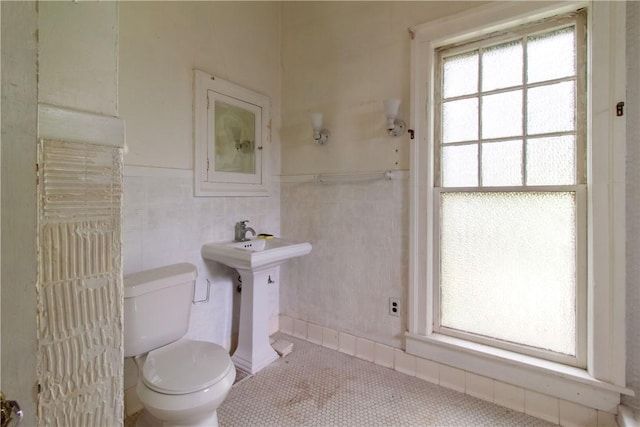 27 E Main St, Sodus, NY 14551 - bathroom with tile patterned floors, tile walls, and wainscoting