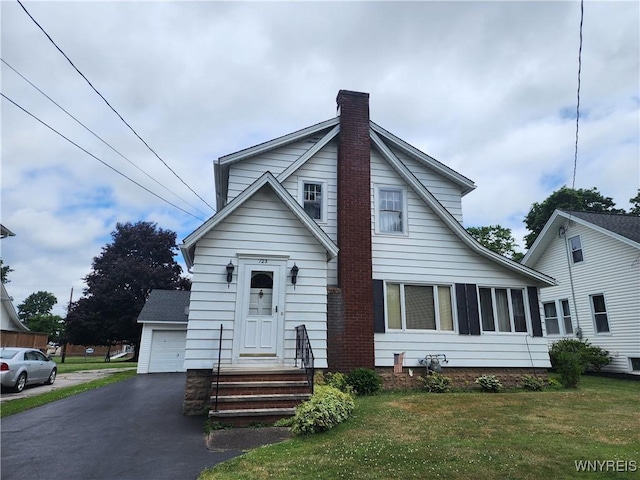 123 Roseland Ave, Ridgeway, NY 14103 - view of front facade with a chimney, a front yard, and a detached garage