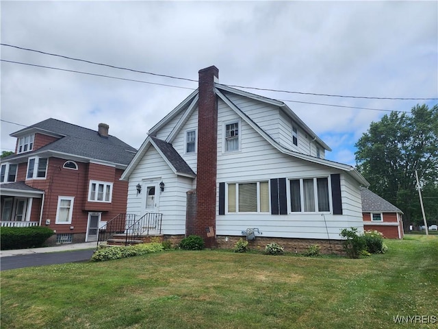 123 Roseland Ave, Ridgeway, NY 14103 - view of front of home featuring a chimney, a front lawn, and a shingled roof