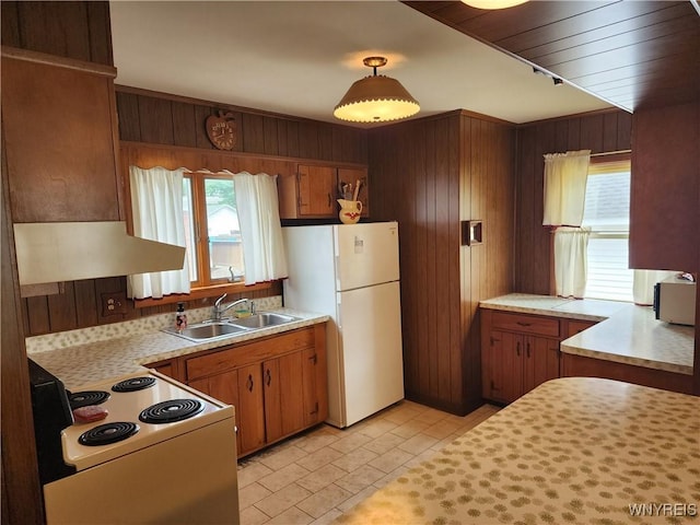 123 Roseland Ave, Ridgeway, NY 14103 - kitchen featuring white appliances, light countertops, wall chimney exhaust hood, wooden walls, and brown cabinets