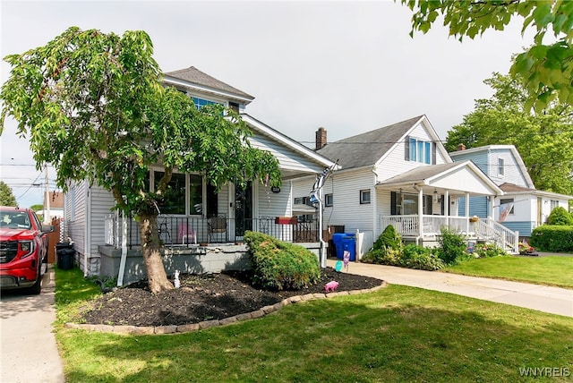 101 Barnsdale Ave, West Seneca, NY 14224 - view of front facade with covered porch, a front yard, and driveway