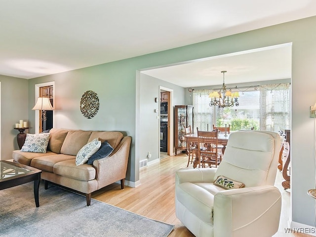 149 Ava Ln, Amherst, NY 14221 - living area featuring a chandelier and light wood-style flooring