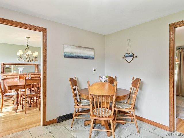 149 Ava Ln, Amherst, NY 14221 - dining room featuring a chandelier and light tile patterned flooring