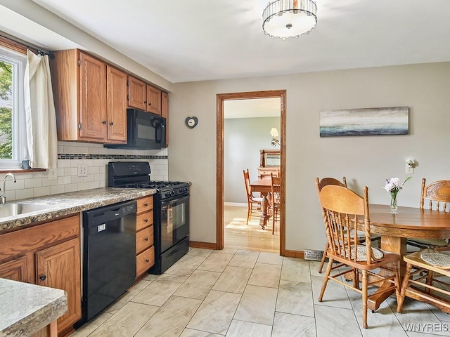 149 Ava Ln, Amherst, NY 14221 - kitchen with black appliances, decorative backsplash, and brown cabinetry