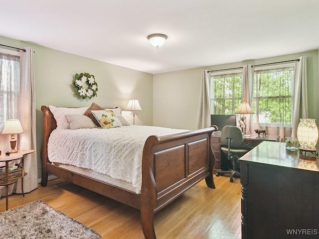 149 Ava Ln, Amherst, NY 14221 - bedroom featuring multiple windows, light wood finished floors, and a desk
