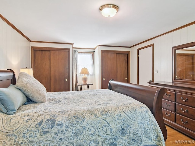 149 Ava Ln, Amherst, NY 14221 - bedroom featuring crown molding, multiple closets, and wood finished floors