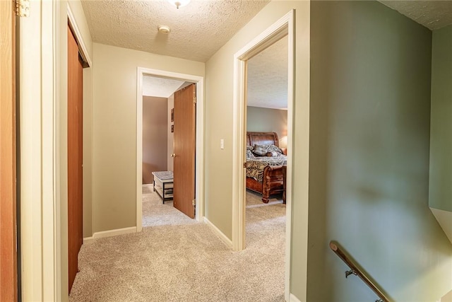 15 Chesapeake Lndg, Henrietta, NY 14586 - hallway featuring carpet flooring, a textured ceiling, and an upstairs landing