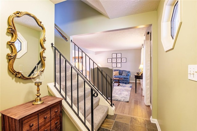 15 Chesapeake Lndg, Henrietta, NY 14586 - stairs featuring a textured ceiling and baseboards