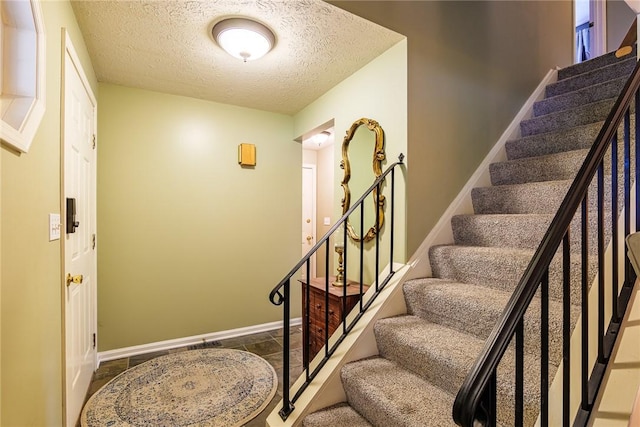 15 Chesapeake Lndg, Henrietta, NY 14586 - stairway featuring a textured ceiling and baseboards