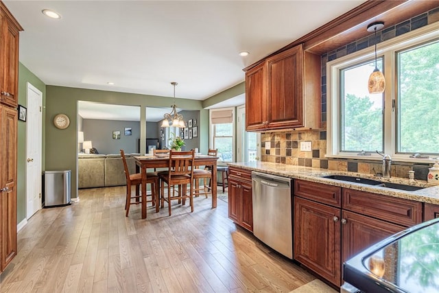 15 Chesapeake Lndg, Henrietta, NY 14586 - kitchen featuring dishwasher, stove, light stone counters, pendant lighting, and light wood-style flooring