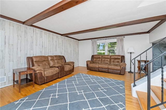 99 Dorian Ln, Greece, NY 14626 - living area with stairway, wood finished floors, beam ceiling, and wooden walls