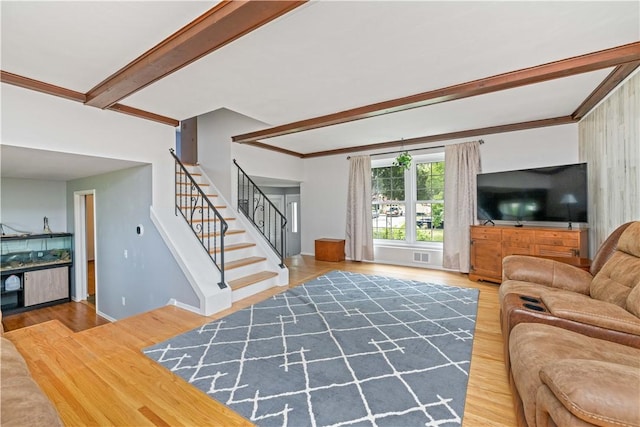 99 Dorian Ln, Greece, NY 14626 - living area featuring wood finished floors, beamed ceiling, and stairway