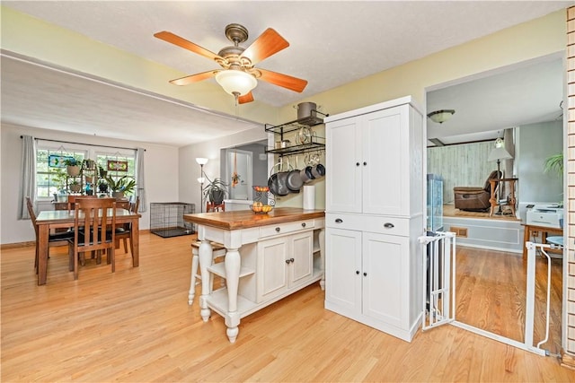 99 Dorian Ln, Greece, NY 14626 - kitchen featuring open shelves, butcher block countertops, light wood-style flooring, white cabinets, and a ceiling fan