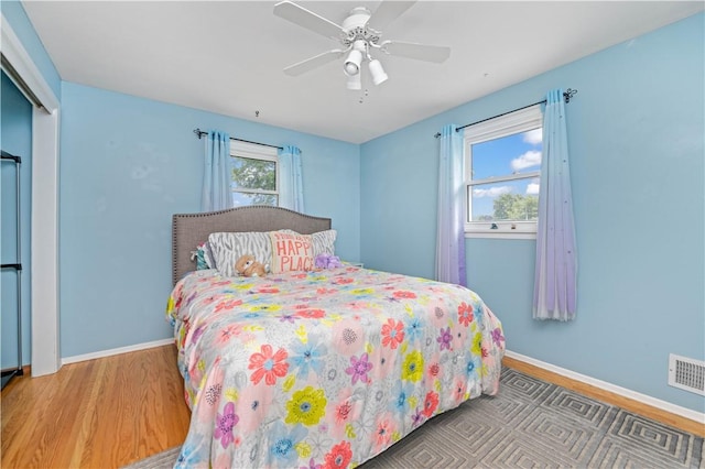 99 Dorian Ln, Greece, NY 14626 - bedroom with wood finished floors, a ceiling fan, and a closet