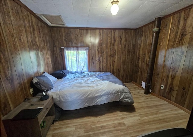 37 Pulaski St, Auburn, NY 13021 - bedroom featuring wood walls and light wood-style flooring