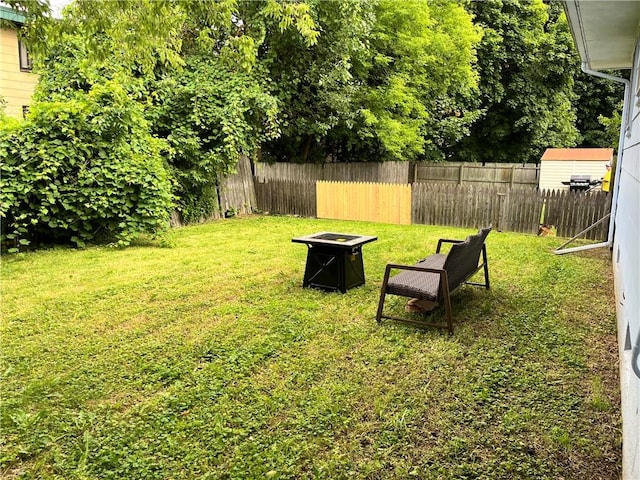 96 Vinal Ave, Irondequoit, NY 14609 - fenced backyard featuring an outdoor fire pit