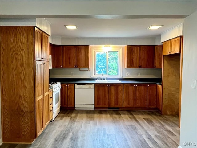 152 W Cayuga St, Oswego, NY 13126 - kitchen featuring white appliances, wood finished floors, dark countertops, and brown cabinets