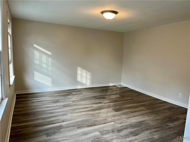 152 W Cayuga St, Oswego, NY 13126 - spare room featuring dark wood-style flooring and baseboards